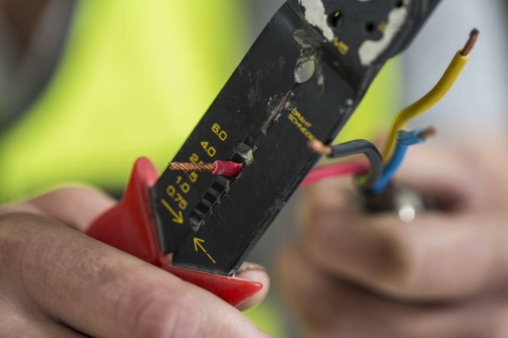 Electrician using wire stripper